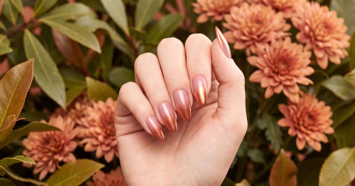 Rose-gold ombré fall manicure photographed outdoors